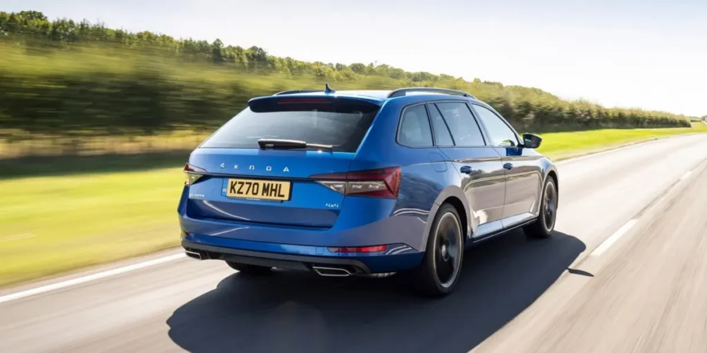 Blue Škoda Superb Combi driving on a highway.